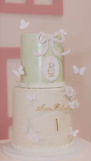Two-tier sage and gingham birthday cake with a sugar bow and butterflies